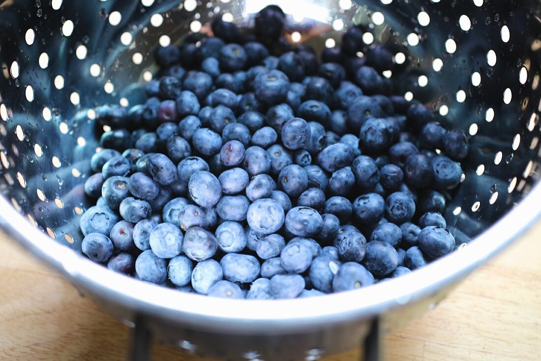 Fresh blueberries in a colander
