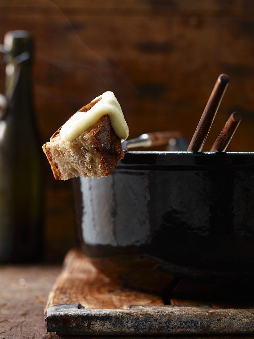 A cheese fondue with a piece of bread