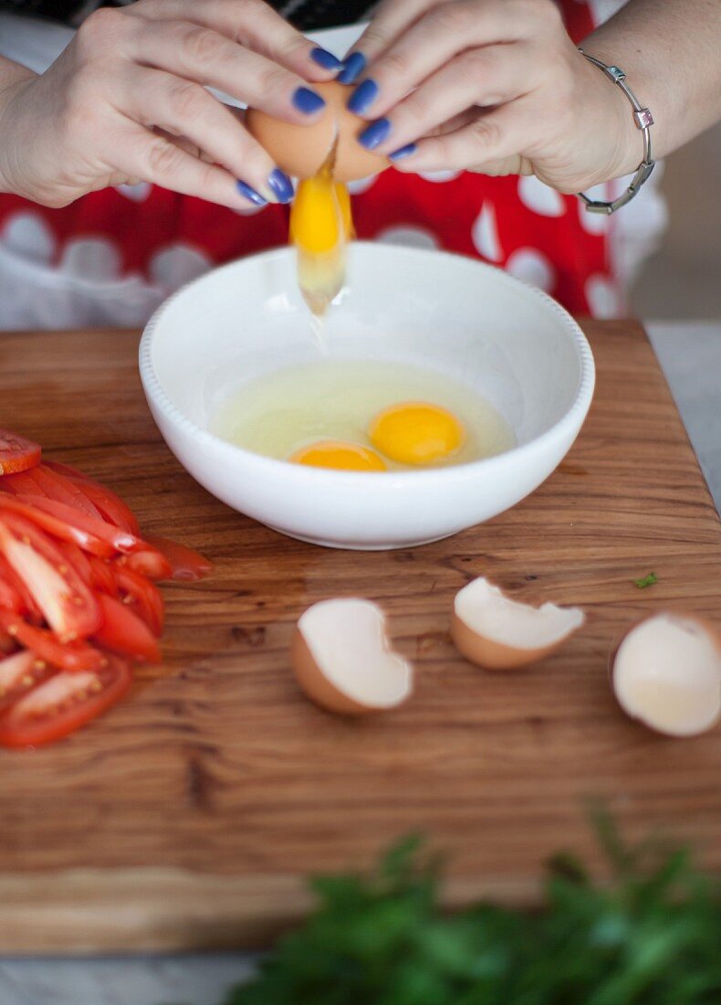 A woman cracking eggs