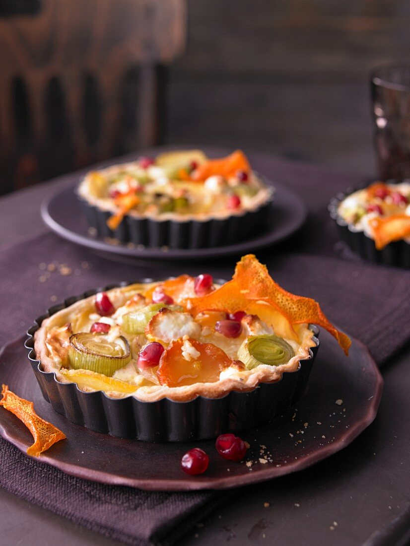 Mini quiche with yellow beets, leek, orange and pomegranate seeds