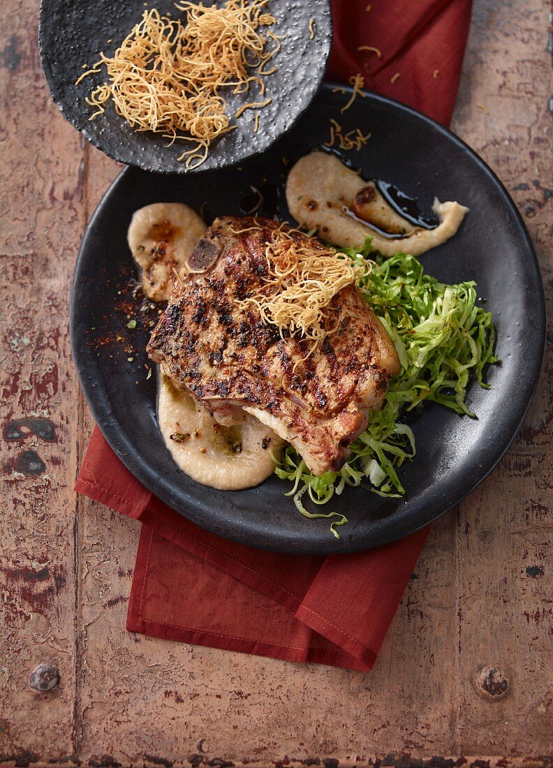 Grilled veal chops on pear butter with parsnip straw