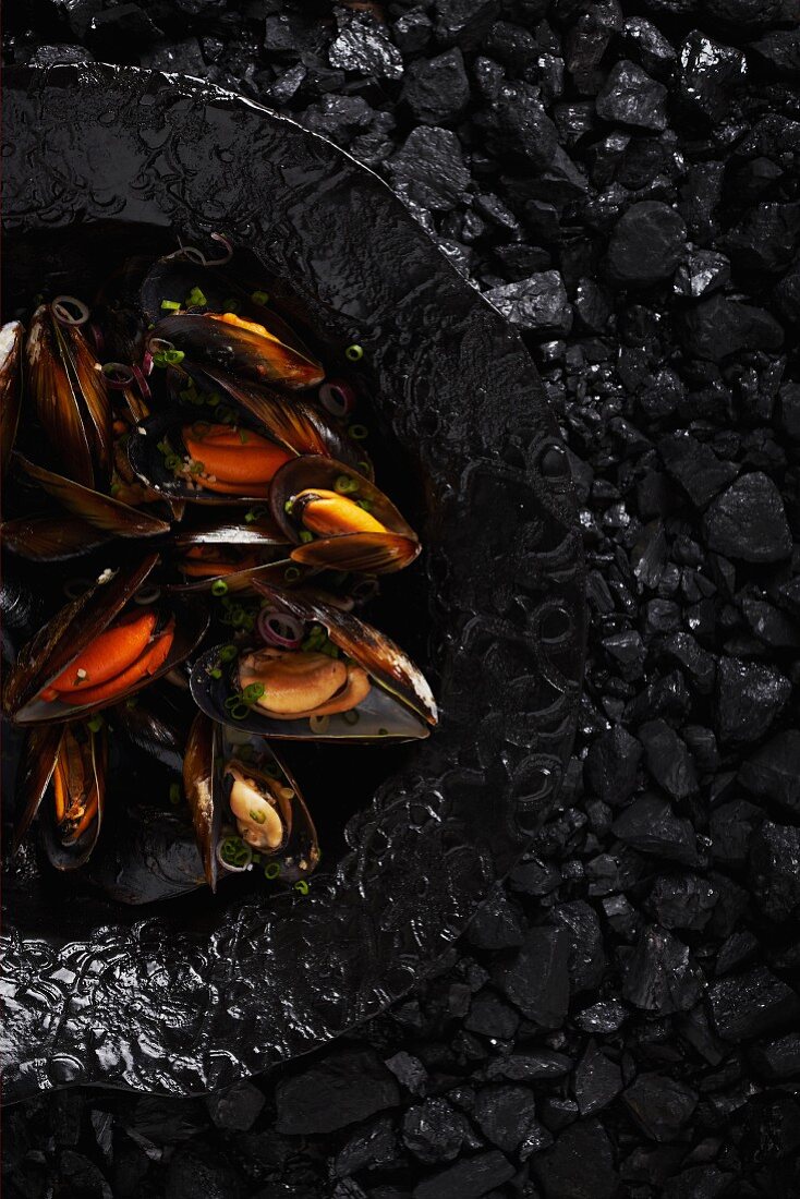 Steamed mussels on a black plate