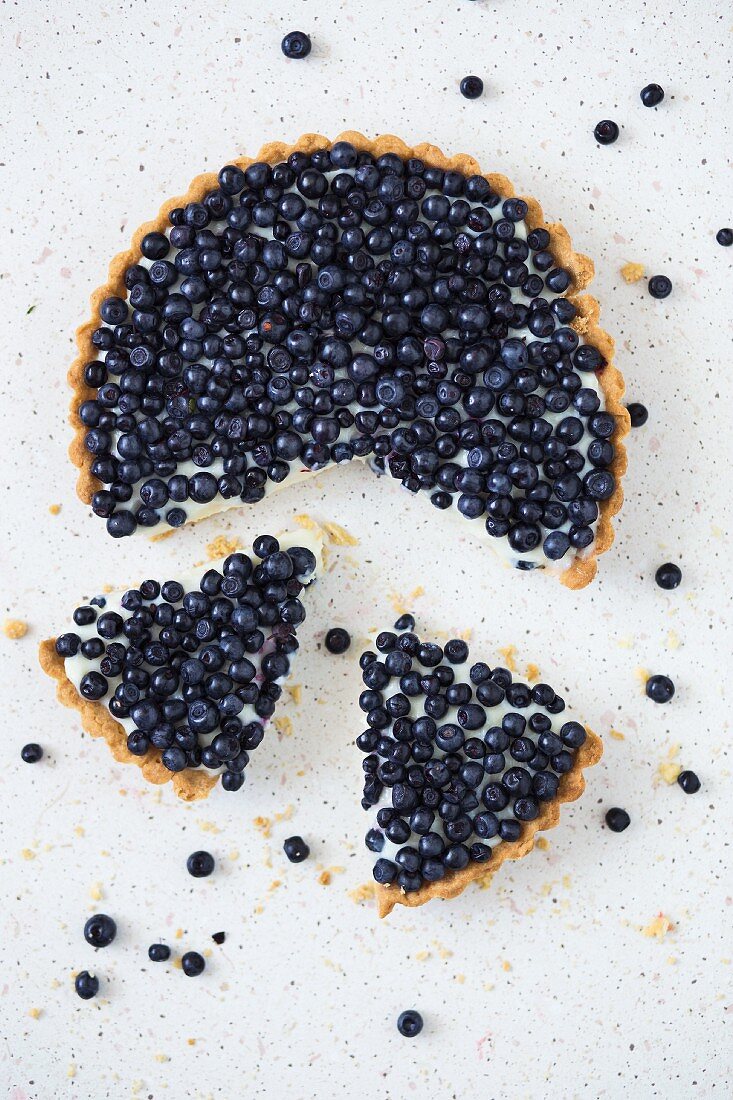 Blueberry tart with two slices cut out