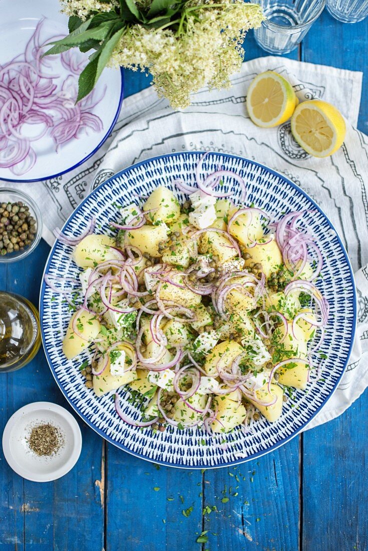 Greek potato salad with capers, onions, feta cheese and olive oil