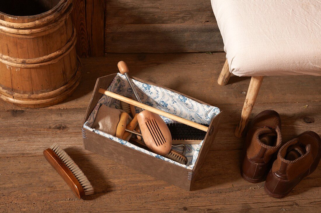 Shoe last and brushes in hand-made shoe-shine box lined with cloth