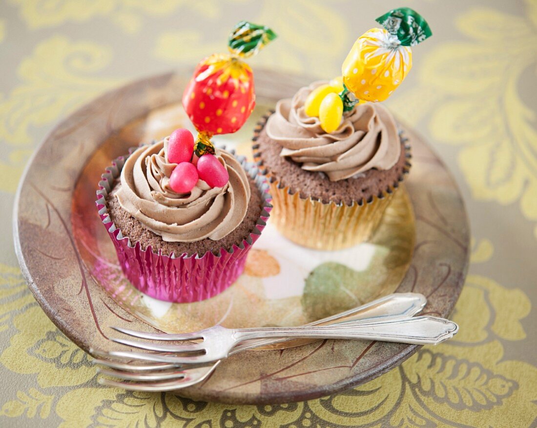 Chocolate cupcakes decorated with lollipops and jelly beans
