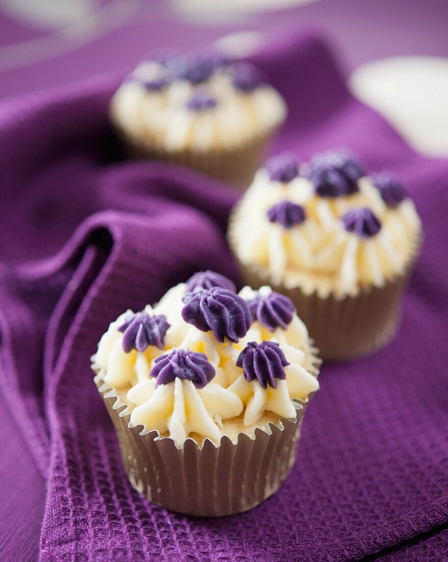 Vanilla cupcakes with violet cream