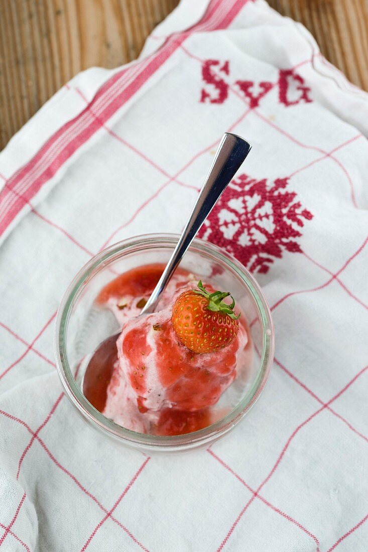 Strawberry ice cream with fruit sauce