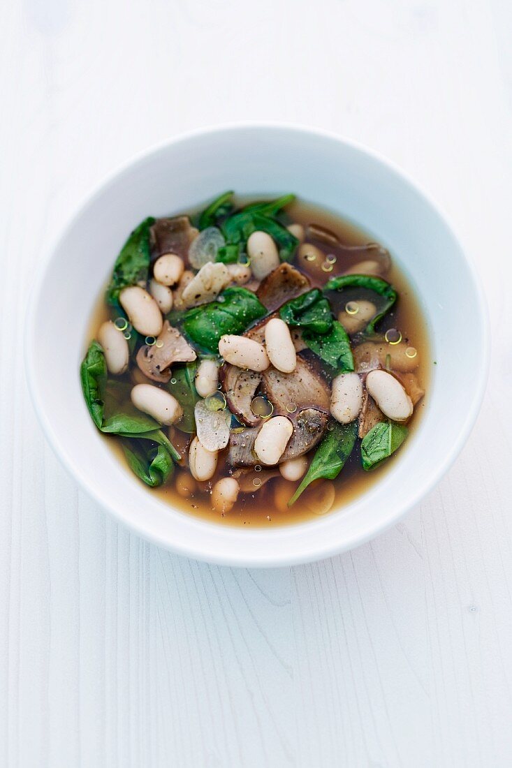 Porcini mushroom bouillon with spinach and white beans