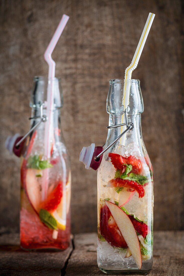 Two fruity cocktails in bottles