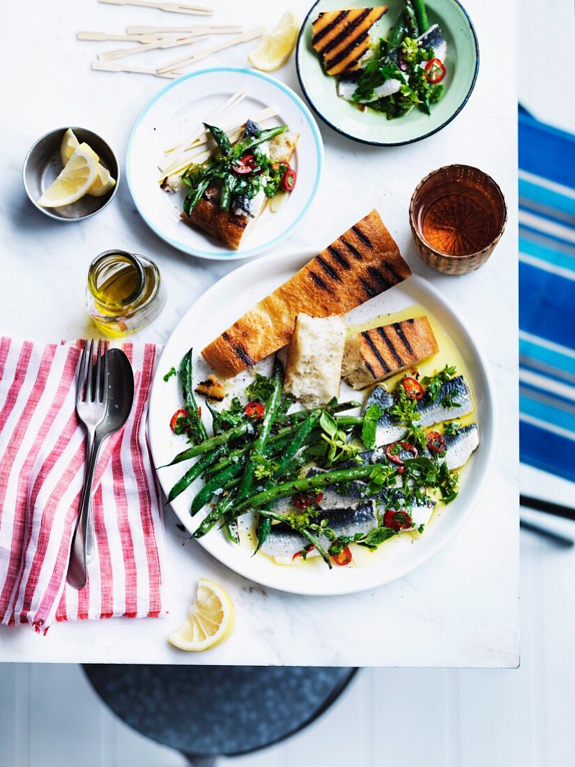 Marinated sardines with garlic and lemon, served with grilled green beans