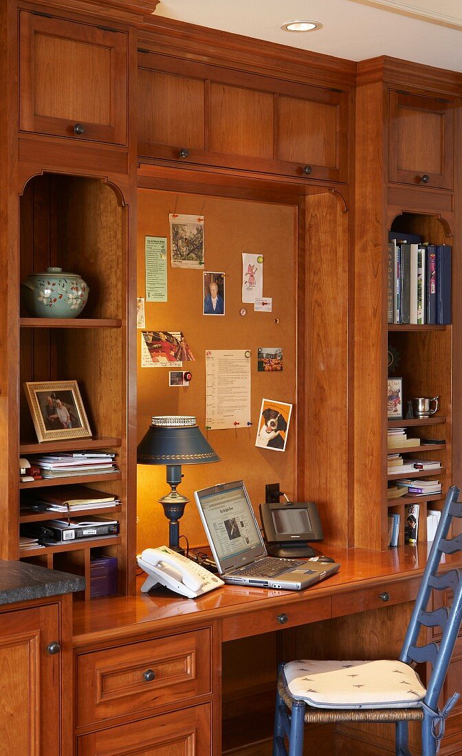 Solid-wood fitted cabinets with shelves and integrated desk in country-house style