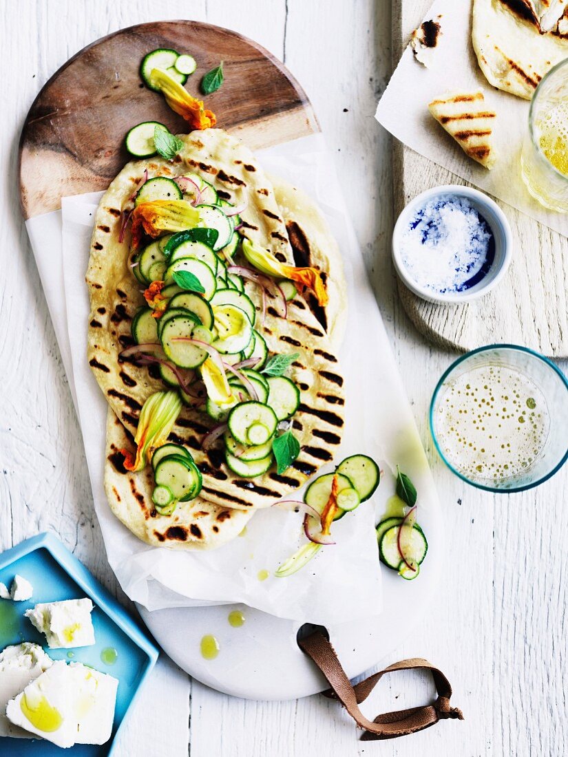 Yoghurt flatbread with courgette, courgette flowers and feta