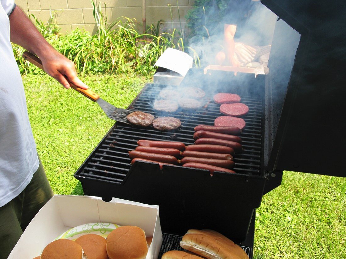 Hamburgers and hot dogs on a barbecue