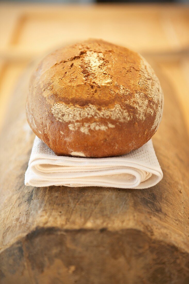 A loaf of bread on a fabric napkin