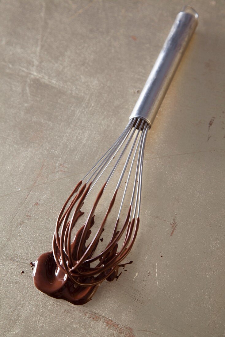 Leftover liquid chocolate on a whisk