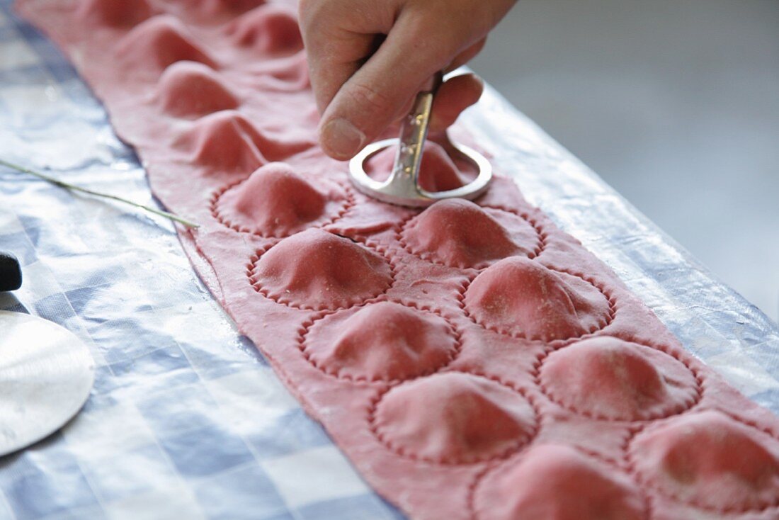 Red ravioli being made