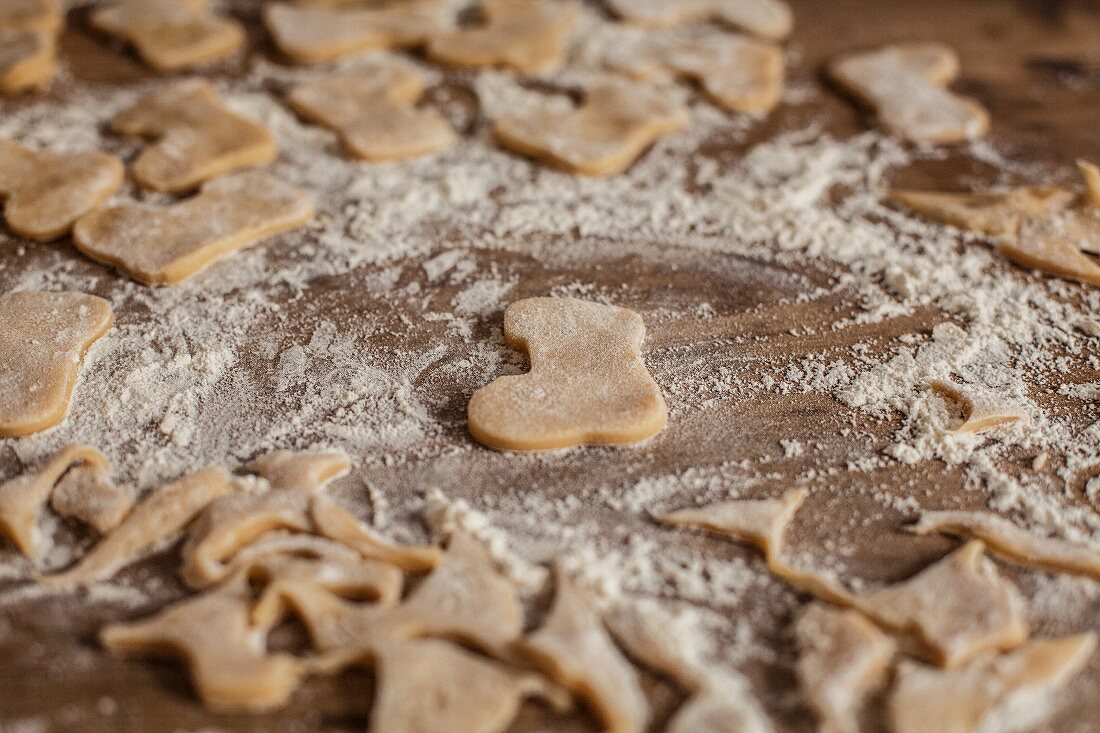 Cut-out biscuits and leftover pastry on a floured work surface