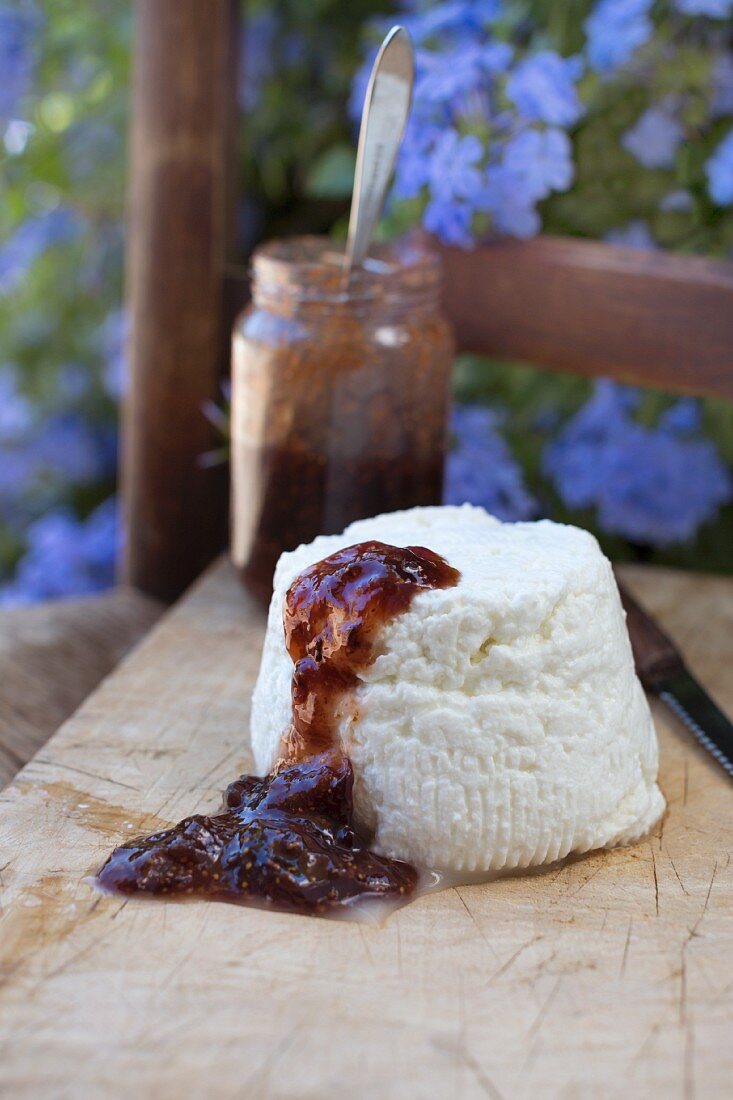 Brocciu (Corsican cream cheese made from sheep or cow's milk) with fig chutney on a wooden board