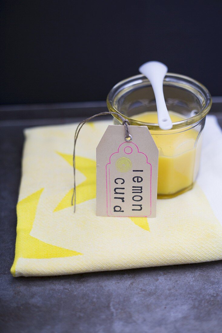 Lemon curd in a jar with a paper tag