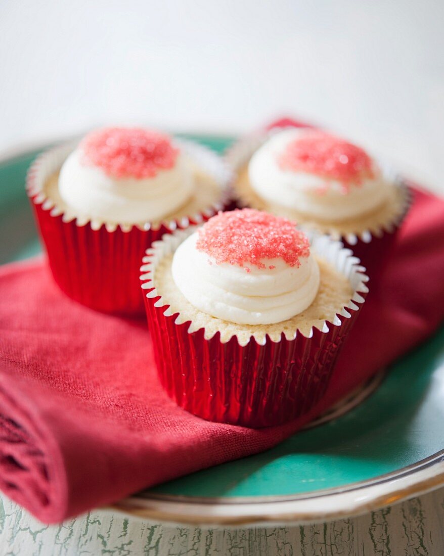 White chocolate cupcakes with red sugar sprinkles