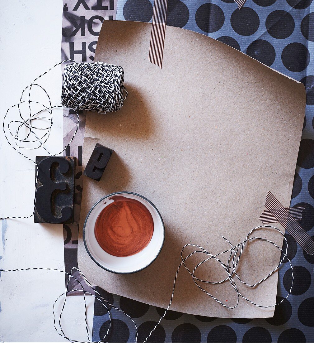 Black and white mood board of paper, washi tape, string and printing blocks