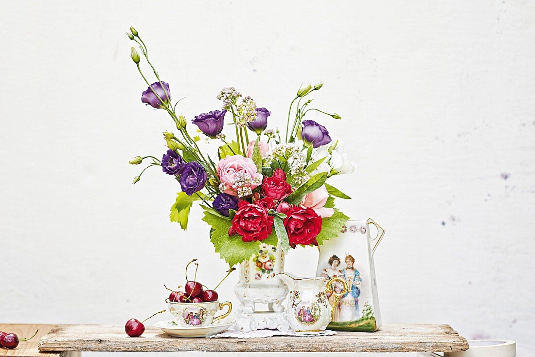 Romantic arrangement with vase of flowers & antique china crockery