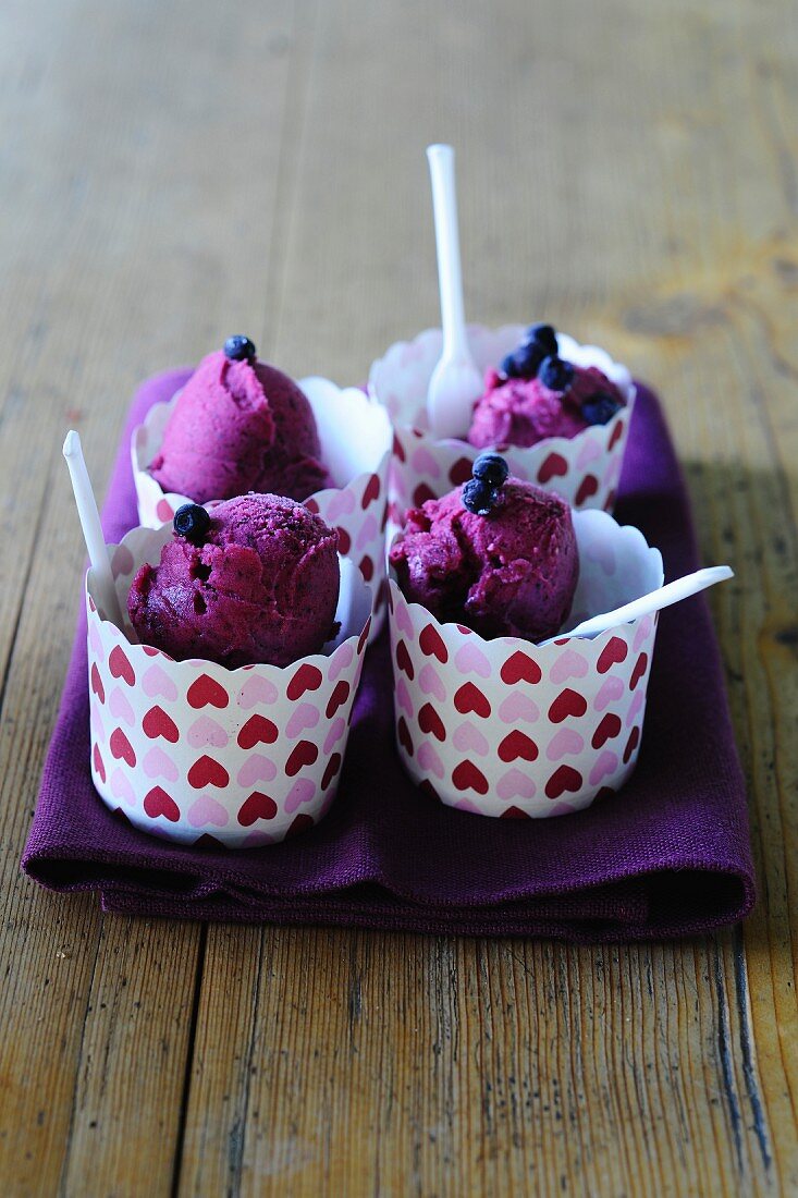 Blueberry ice cream in dessert cups decorated with hearts