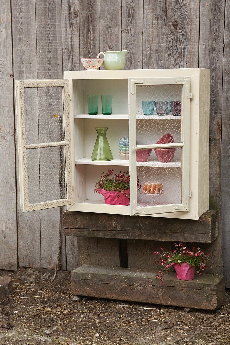 Wall-mounted cabinet hand-made from old windows