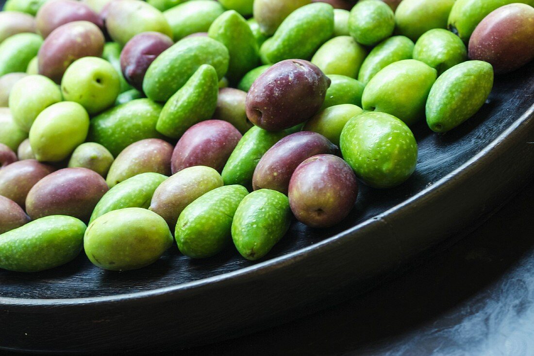 Fresh olives in a black bowl