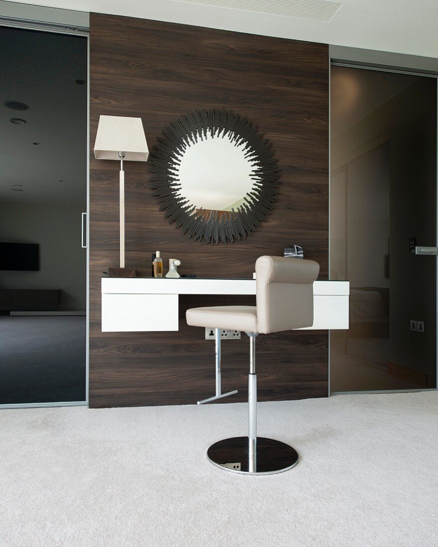 Luxurious dressing table with bar stool and large mirror on dark wooden wall