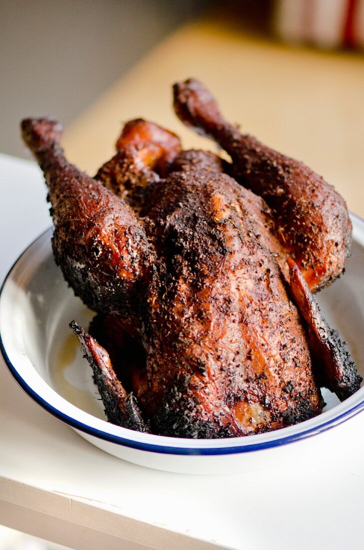 Spicy grilled chicken in an enamel bowl