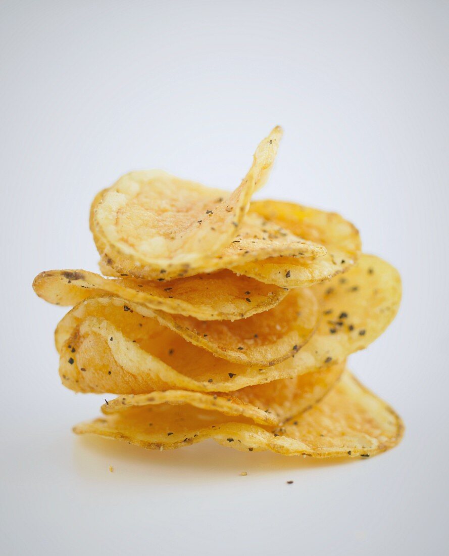A stack of crisps on a white surface