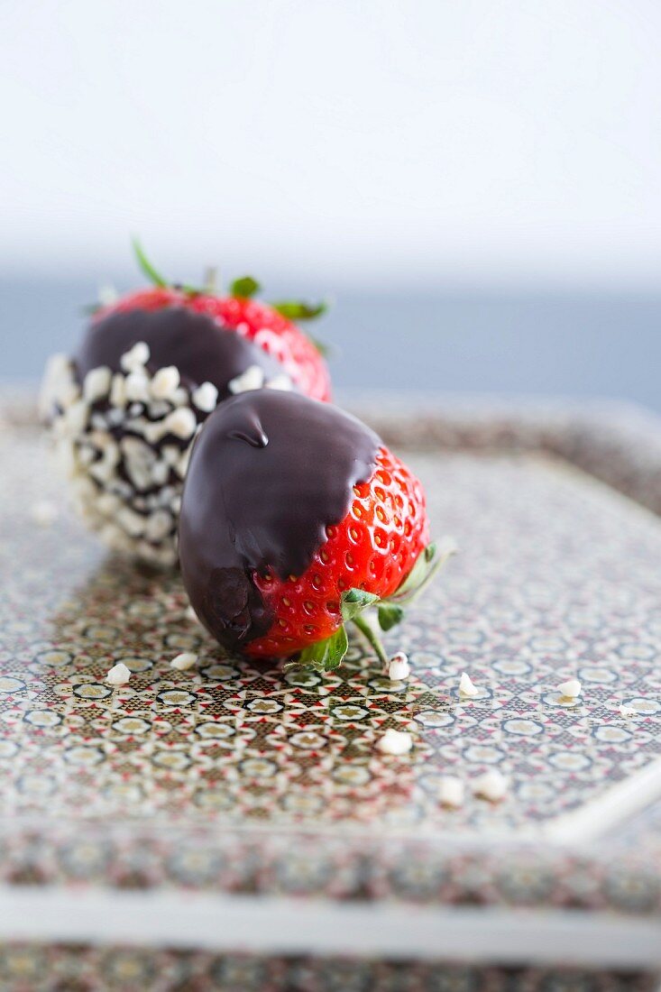 Chocolate-coated strawberries and chopped almonds