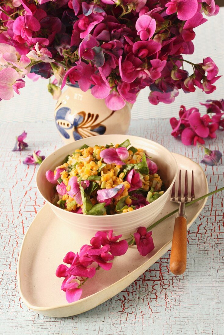 Yellow lentil salad with flowers and wild herbs