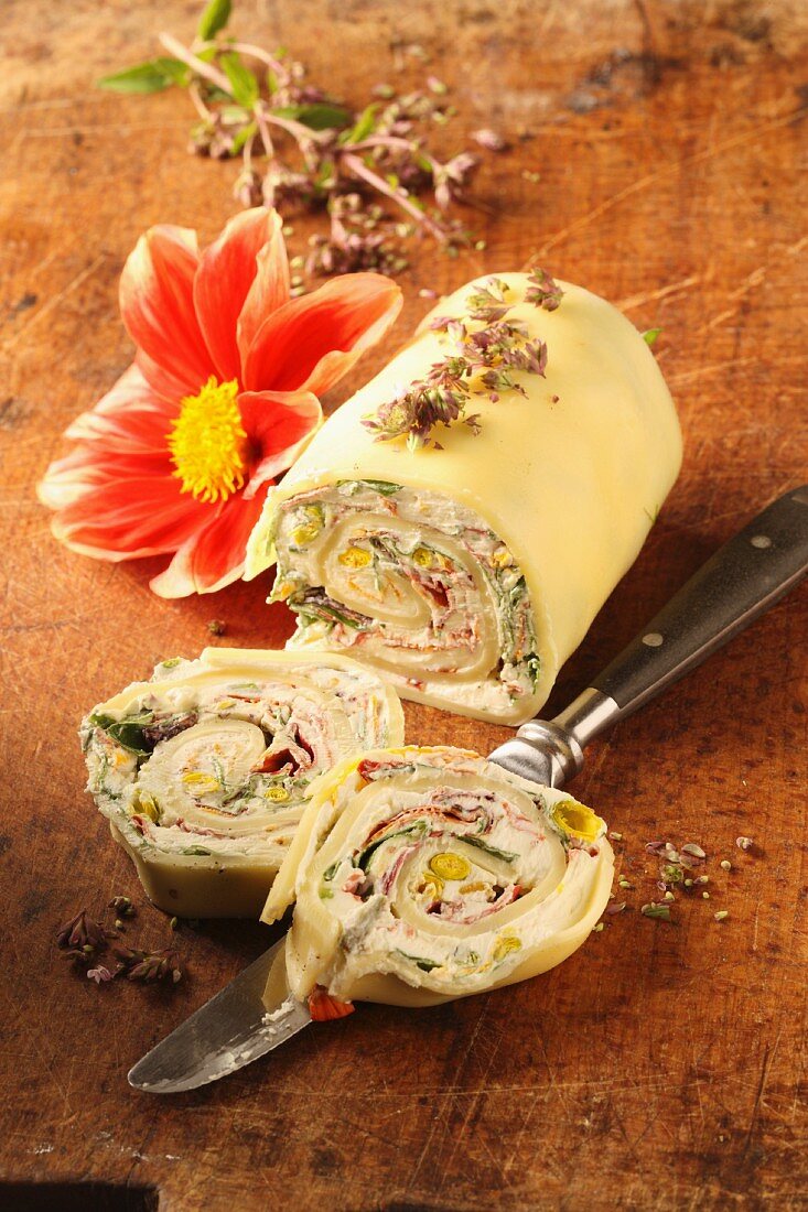 A pasta roll filled with cream cheese and edible flowers