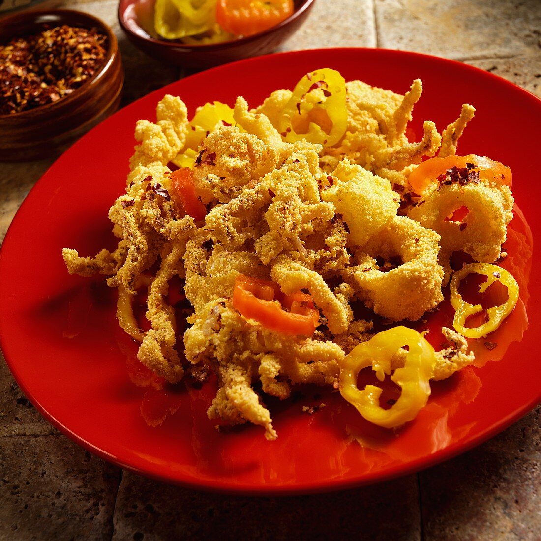 Fried squid diablo with red and yellow pickled peppers and chilli flakes