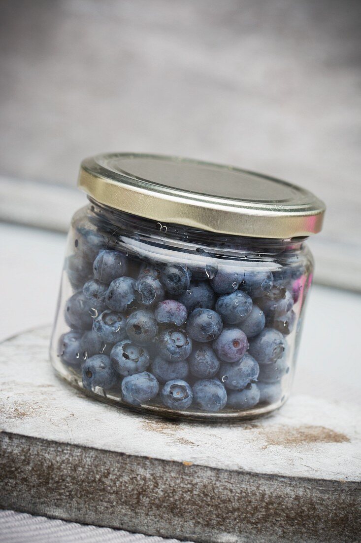 Fresh blueberries in a screw-top jar