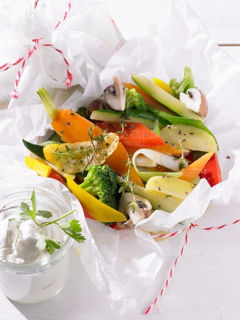 Colourful vegetables with herbs in parchment paper