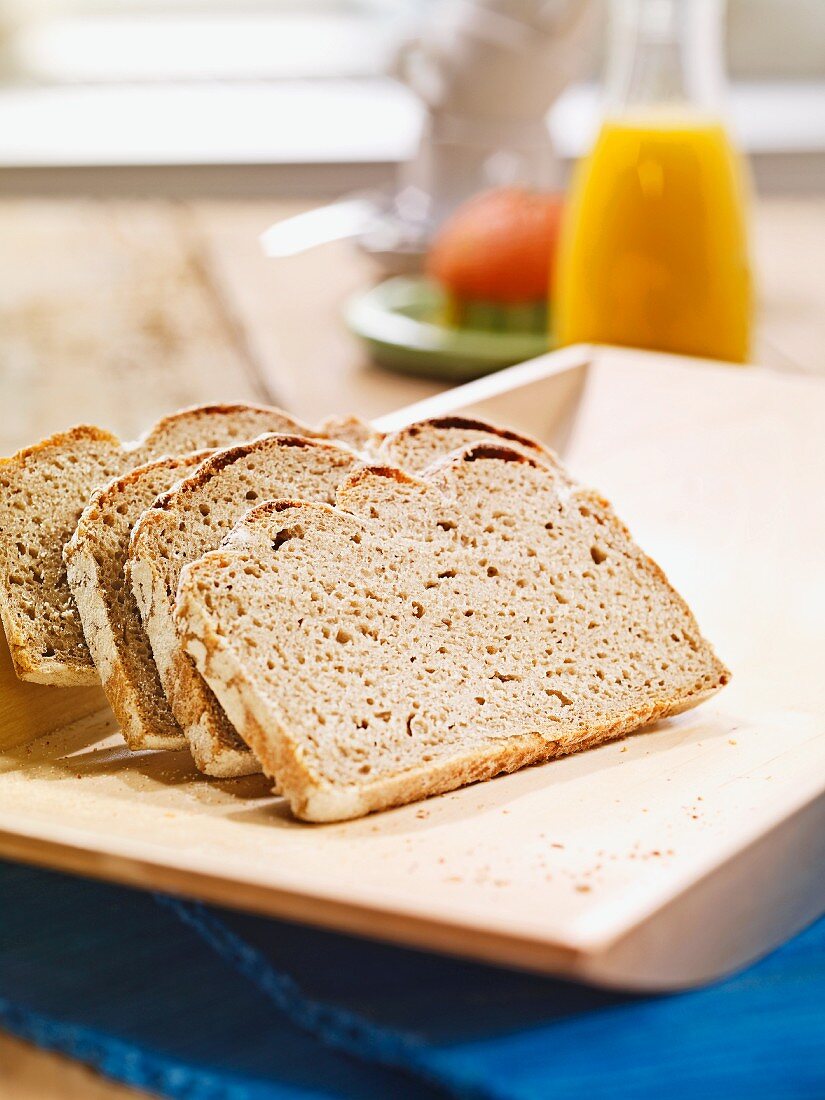 Sliced rye bread on a flat wooden tray