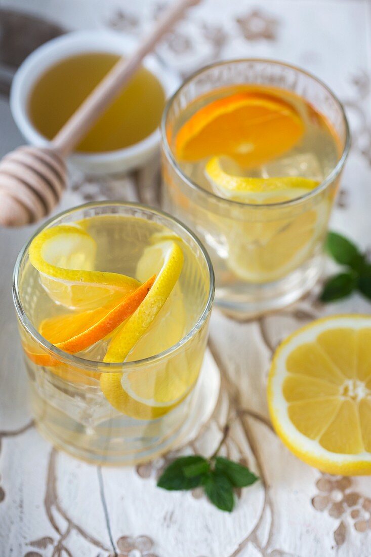 Water flavoured with citrus fruit slices and honey