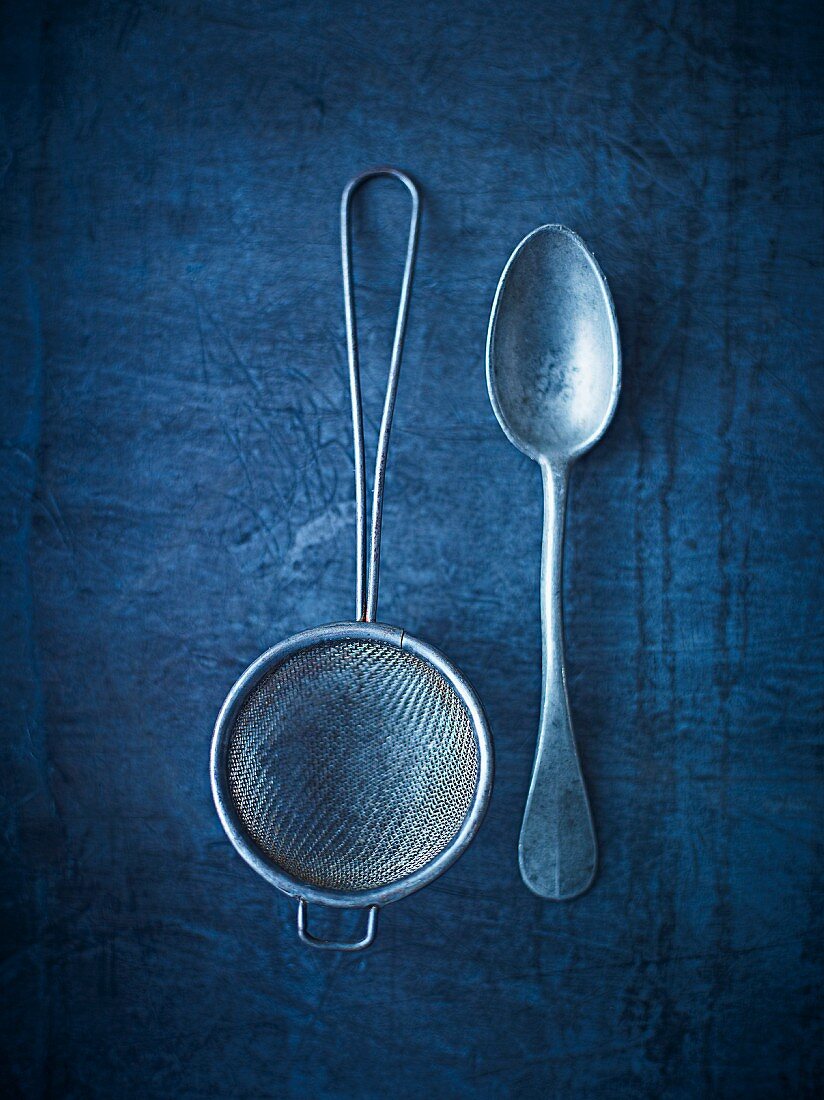 An old sieve and an antique spoon (seen from above)