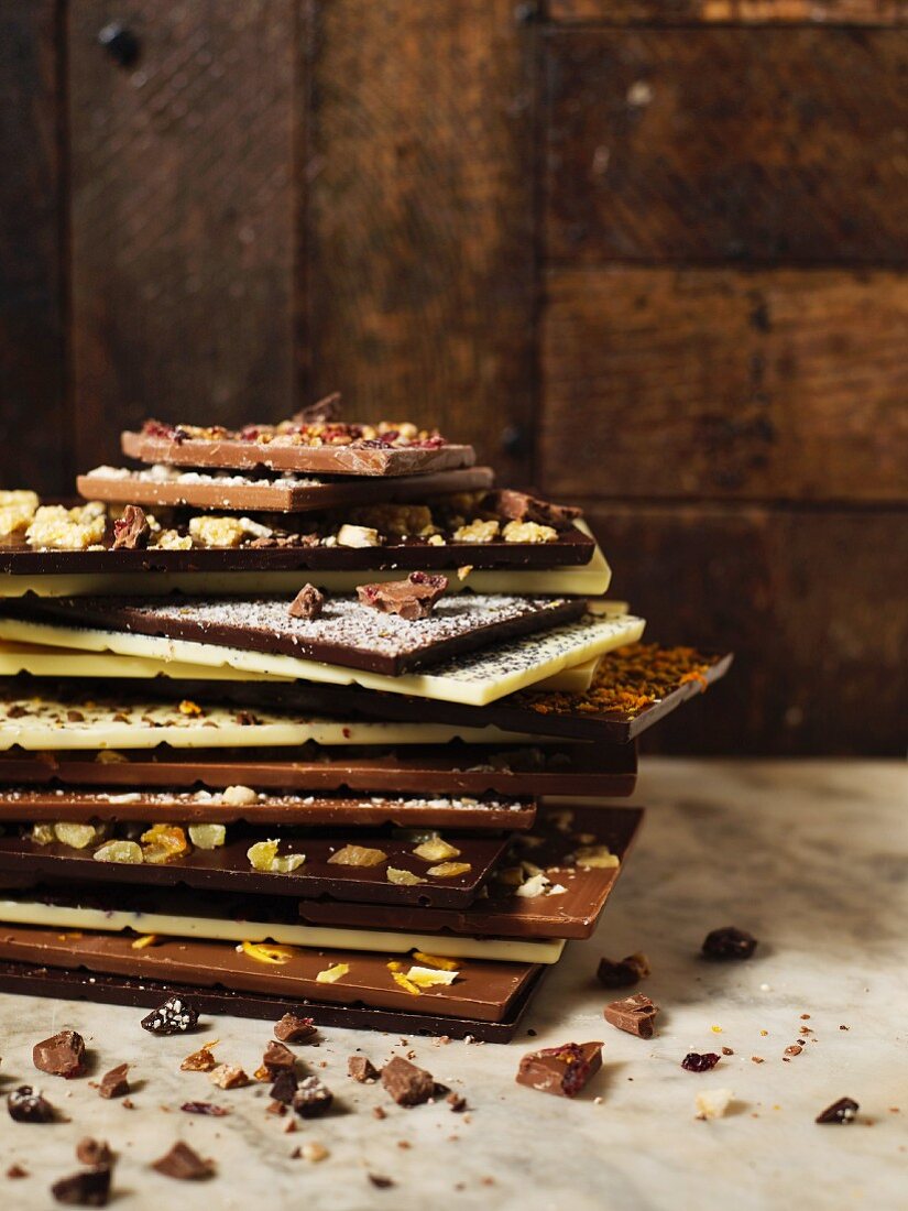 A stack of various bars of chocolate