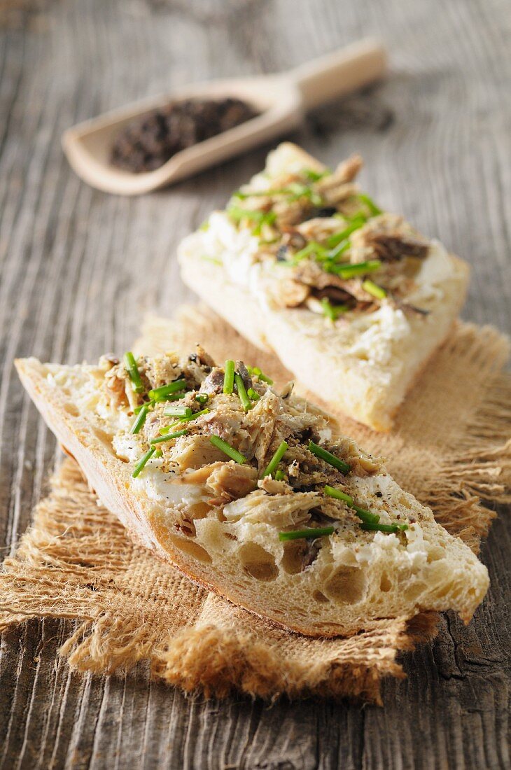 Slices of bread topped with mackerel rillettes, chives and three types of pepper