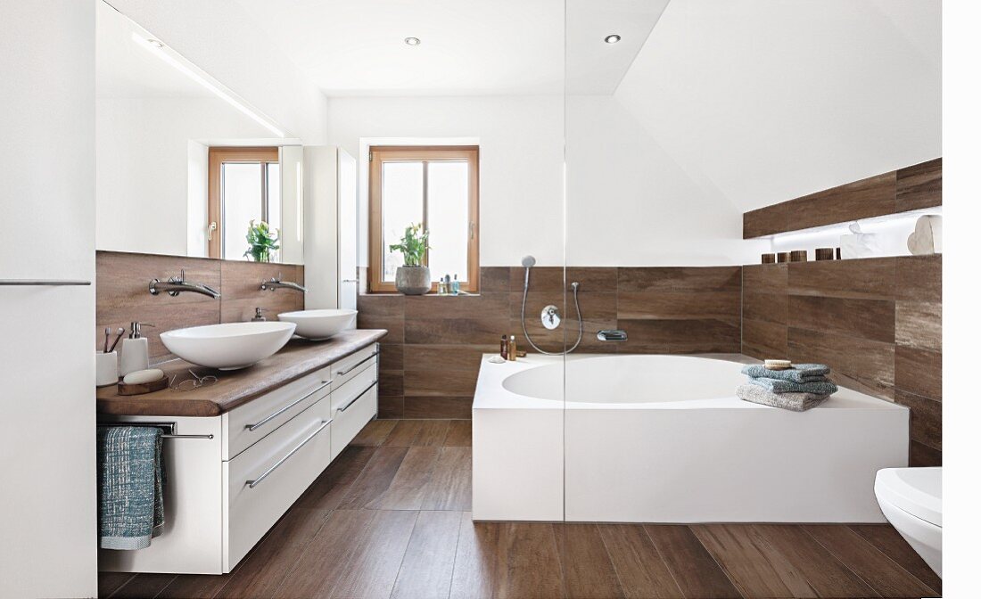 A designer bathroom with a square bathtub and wooden-style tiles