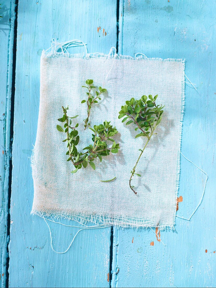Fresh thyme on a light blue wooden surface
