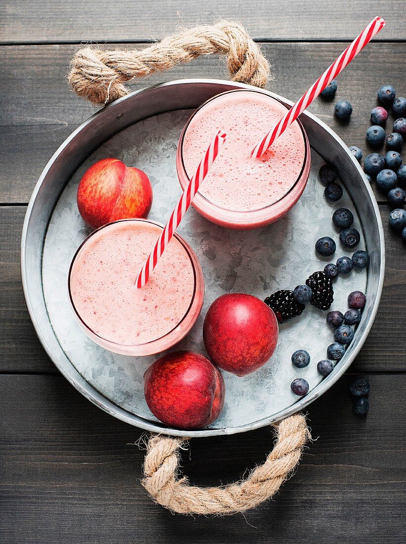 Fresh smoothies with nectarines, blueberries and blackberries