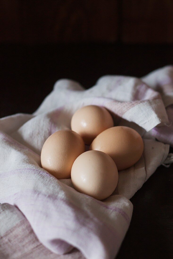 Four brown chicken's egg on a cloth