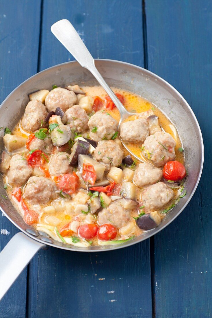 Beef meatballs with tomatoes and aubergine in a creamy sauce