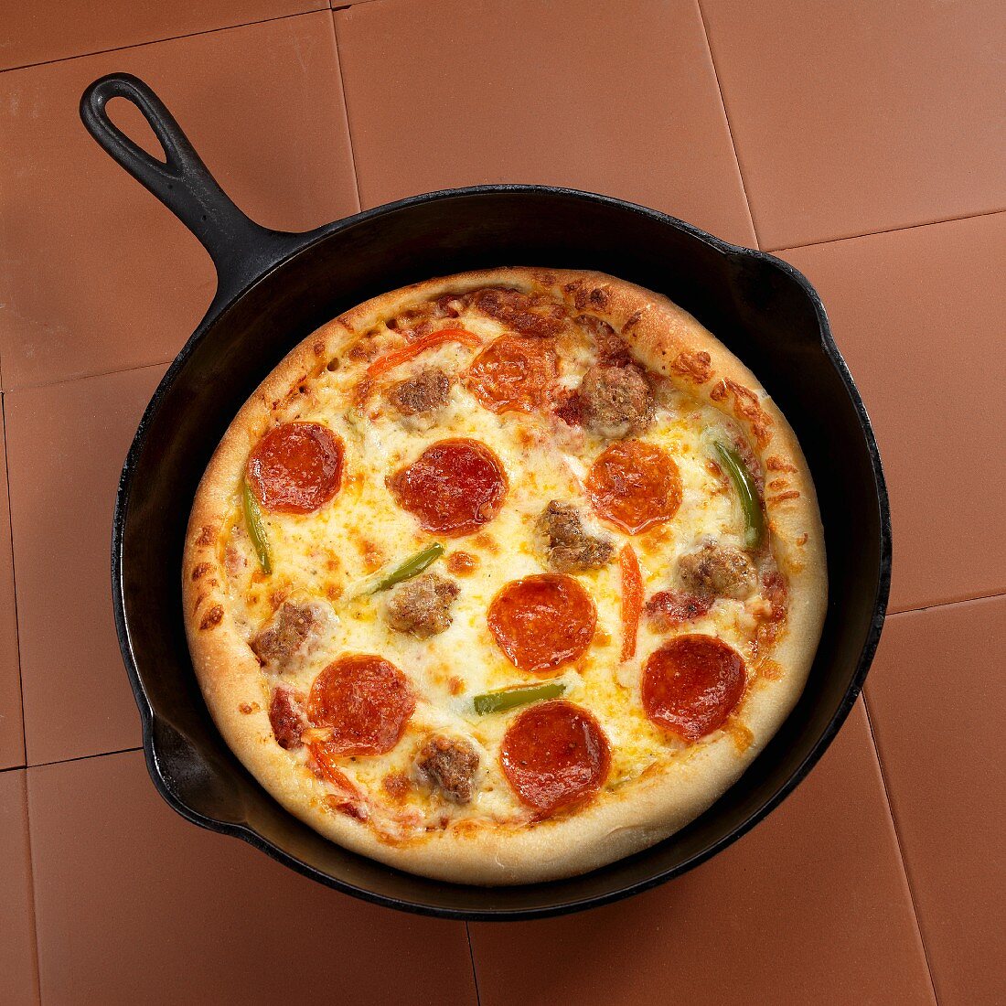 A pan pizza with sausage and peppers